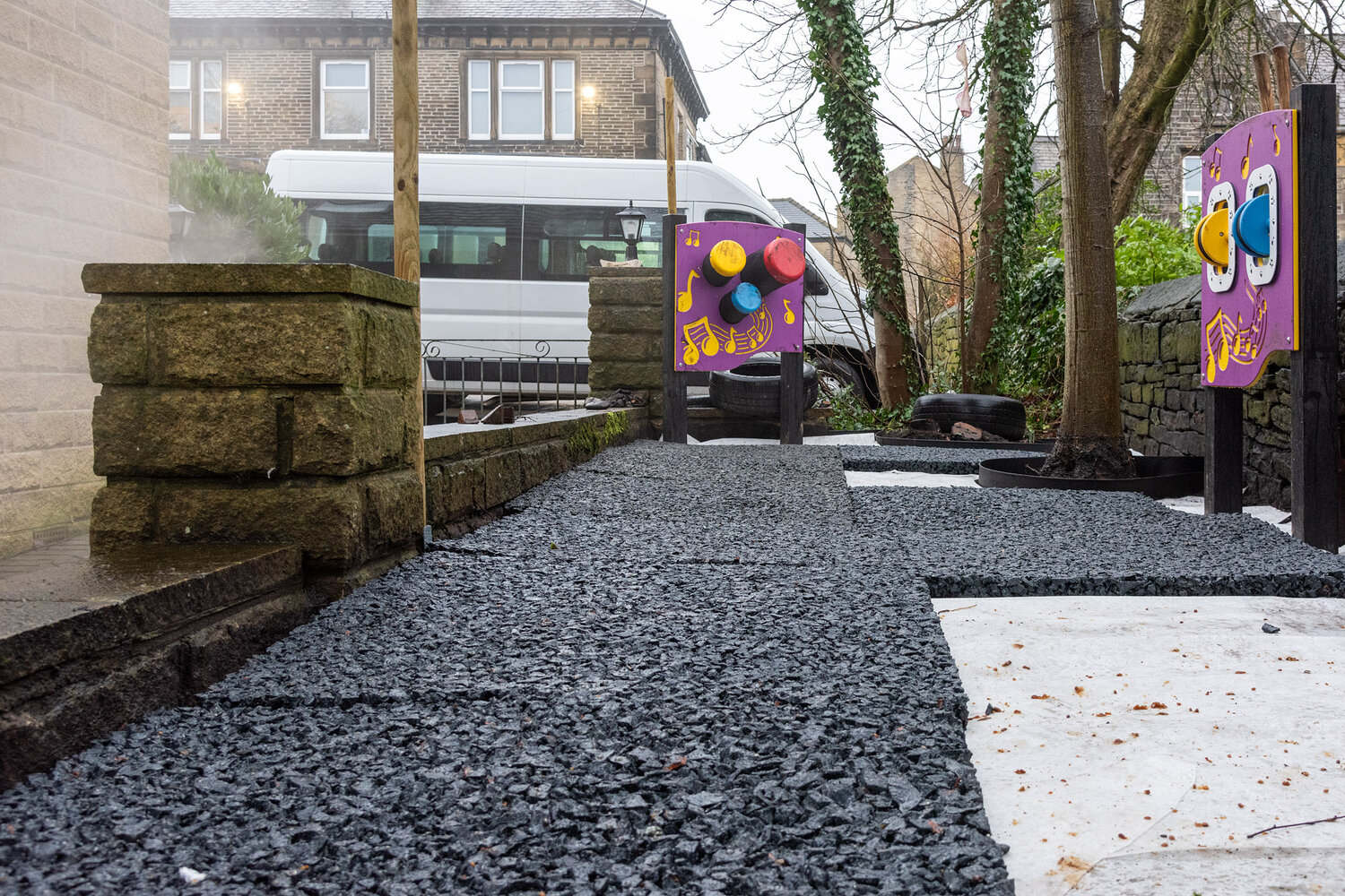 SBR rubber base layer installed over drainage mats with sensory play panels
